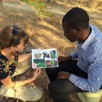 Valerie Stull showing someone insect images