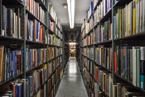 Jacob Peterson, a junior studying geography, uses his laptop computer while working amid the quiet aisles of the north stacks at Memorial Library at the University of Wisconsin-Madison on Sept. 30, 2018. (Photo by Jeff Miller / UW-Madison)