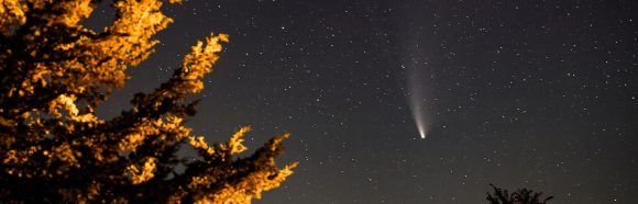 Comet NEOWISE  officially called C/2020 F3 (NEOWISE)  passes overhead in the night sky in Cross Plains, Wis., during summer on July 22, 2020. The view is from the grounds of the University of Wisconsin-Madisons Pine Bluff Observatory. July 22-23 is a special time to see Comet NEOWISE as it will be closest to Earth, passing at some 64 million miles (103 million km) from our planet. On the nights around its closest approach  although youll probably still need binoculars to spot this celestial visitor  the comet will be visible at the same time we see a beautiful waxing crescent moon in the western twilight sky. (Photo by Jeff Miller / UW-Madison)