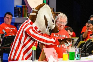 University of Wisconsin-Madison mascot Bucky Badger helps Chemistry Professor Bassam Shakhashiri perform a chemistry experiment during the second of two 50th anniversary shows of "Once Upon a Christmas Cheery in the Lab of Shakhashiri" to a sellout audience at the Middleton Performing Arts Center in Middleton, Wis., on Dec. 1, 2019. Started in 1970 by Shakhashiri as an end-of-the-fall-semester freshman chemistry lecture, the tradition has evolved into an annual science outreach event enjoyed by hundreds of people each year. The show is frequently recorded and broadcast on PBS Wisconsin. (Photo by Jeff Miller / UW-Madison)