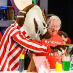 University of Wisconsin-Madison mascot Bucky Badger helps Chemistry Professor Bassam Shakhashiri perform a chemistry experiment during the second of two 50th anniversary shows of "Once Upon a Christmas Cheery in the Lab of Shakhashiri" to a sellout audience at the Middleton Performing Arts Center in Middleton, Wis., on Dec. 1, 2019. Started in 1970 by Shakhashiri as an end-of-the-fall-semester freshman chemistry lecture, the tradition has evolved into an annual science outreach event enjoyed by hundreds of people each year. The show is frequently recorded and broadcast on PBS Wisconsin. (Photo by Jeff Miller / UW-Madison)