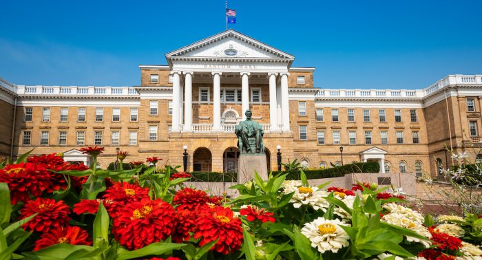 Bascom Hall is framed with red and white zinnia blooms during summer at the University of Wisconsin-Madison on August 10, 2021. (Photo by Bryce Richter / UW-Madison)