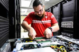 Considered essential staff under COVID-19, Division of Information Technology (DoIT) operations technologist Dan Rosenberg upgrades computing hardware in a server in DoIT’s data center in Computer Sciences and Statistics at the University of Wisconsin-Madison on April 15, 2020. The majority of the UW-Madison campus is closed in response to the rapidly-evolving health concerns of the global coronavirus (COVID-19) pandemic. (Photo by Jeff Miller / UW-Madison)