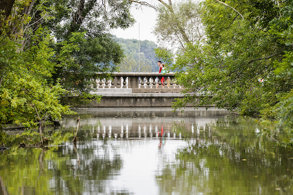 Pedestrians walk across a Willow Creek bridge as rising water from Lake Mendota floods the University Bay shoreline at the University of Wisconsin-Madison on Aug. 24, 2018. Area lake levels continue to rise after a record-breaking storm on Aug. 20 dumped more than 10-inches of rain on parts of Madison and Dane County. (Photo by Jeff Miller / UW-Madison)