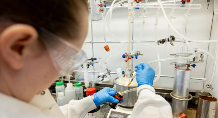 Jillian Kyzer, a medicinal chemist and staff scientist in the School of Pharmacy, synthesizes a chemical reaction as part of her work in the Wenthur Lab, which explores how psychedelics can improve mental health disorders. The investment from WARF will help fund research to produce foundational data around brain health. PHOTO: SHARON VANORNY